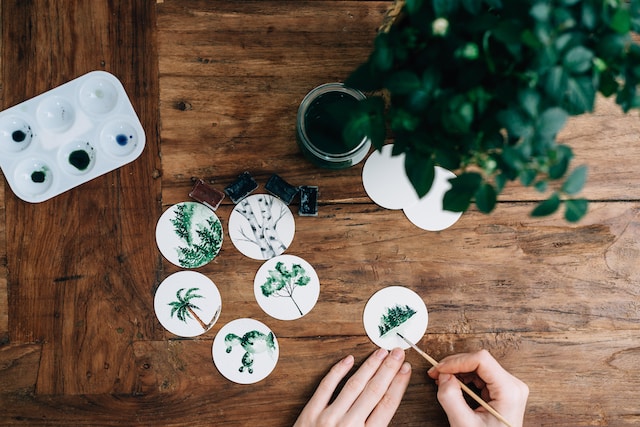 Person painting trees on paper